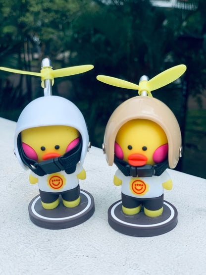 Little yellow ducks with helmets to put on a motorcycle or car